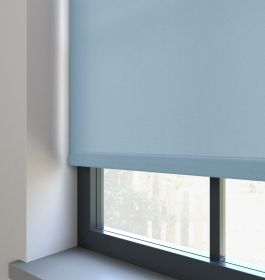 Our Burst Sky Blue dimout Roller blind in a living room window.