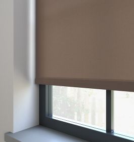 A dimout roller blind in a window