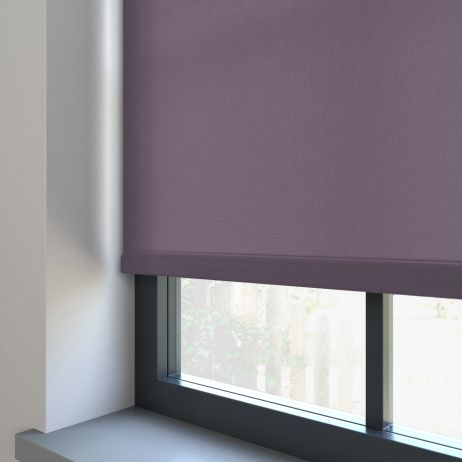 Our Burst Damson dimout roller blind in the living room window.