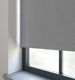 Our Amor Polished Stone Roller blind in a living room window.