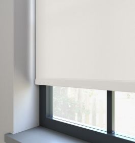 A white dimout roller blind in a window