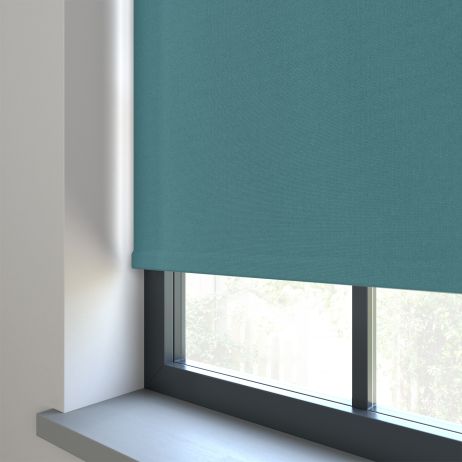 Our Amor Muted Teal Roller blind in a living room window.