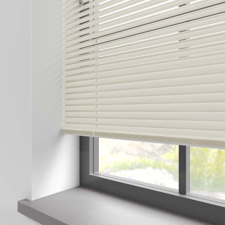 A beige aluminium blind in a kitchen window