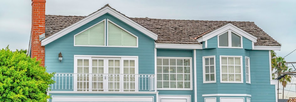 Bay windows dressed with blinds and curtains in blue home