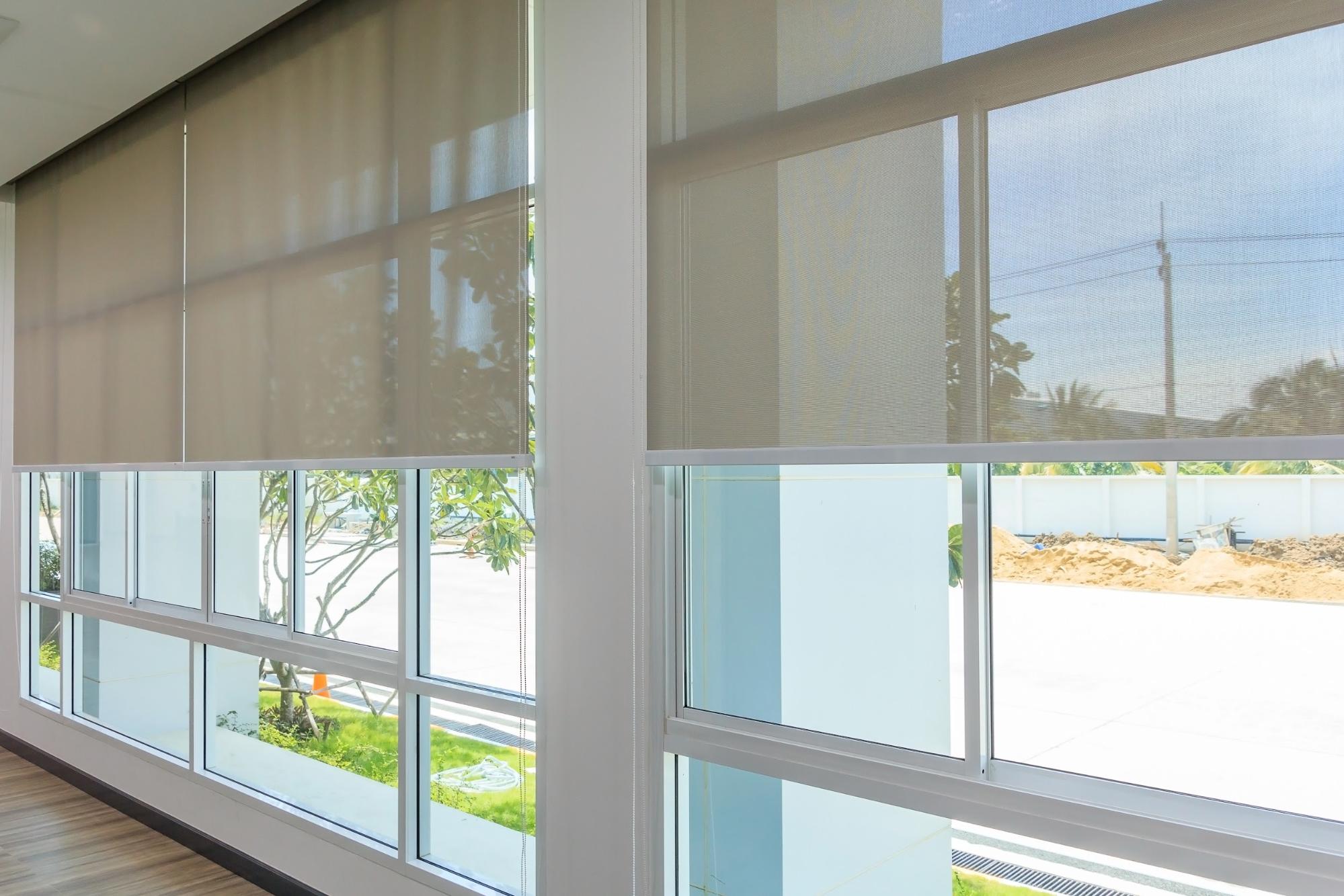 Floor to ceiling windows with blinds rolled halfway up